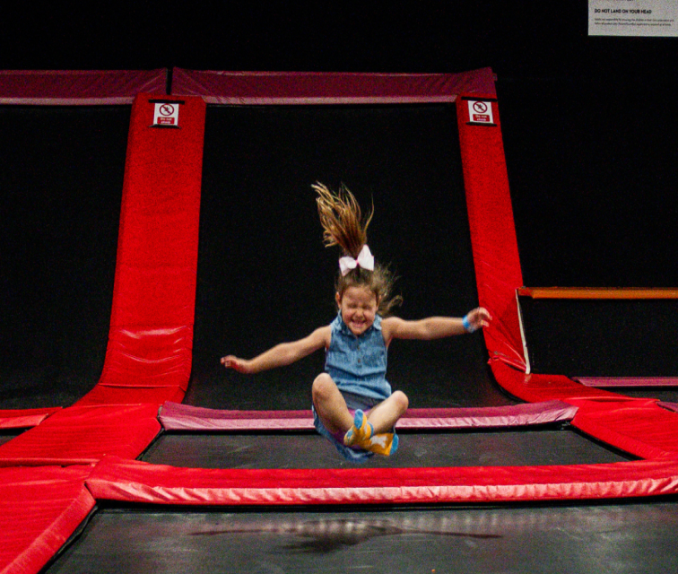 Child jumping on trampoline at Lava Island