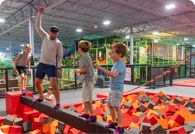 A family playing together on the trampolines at Lava Island